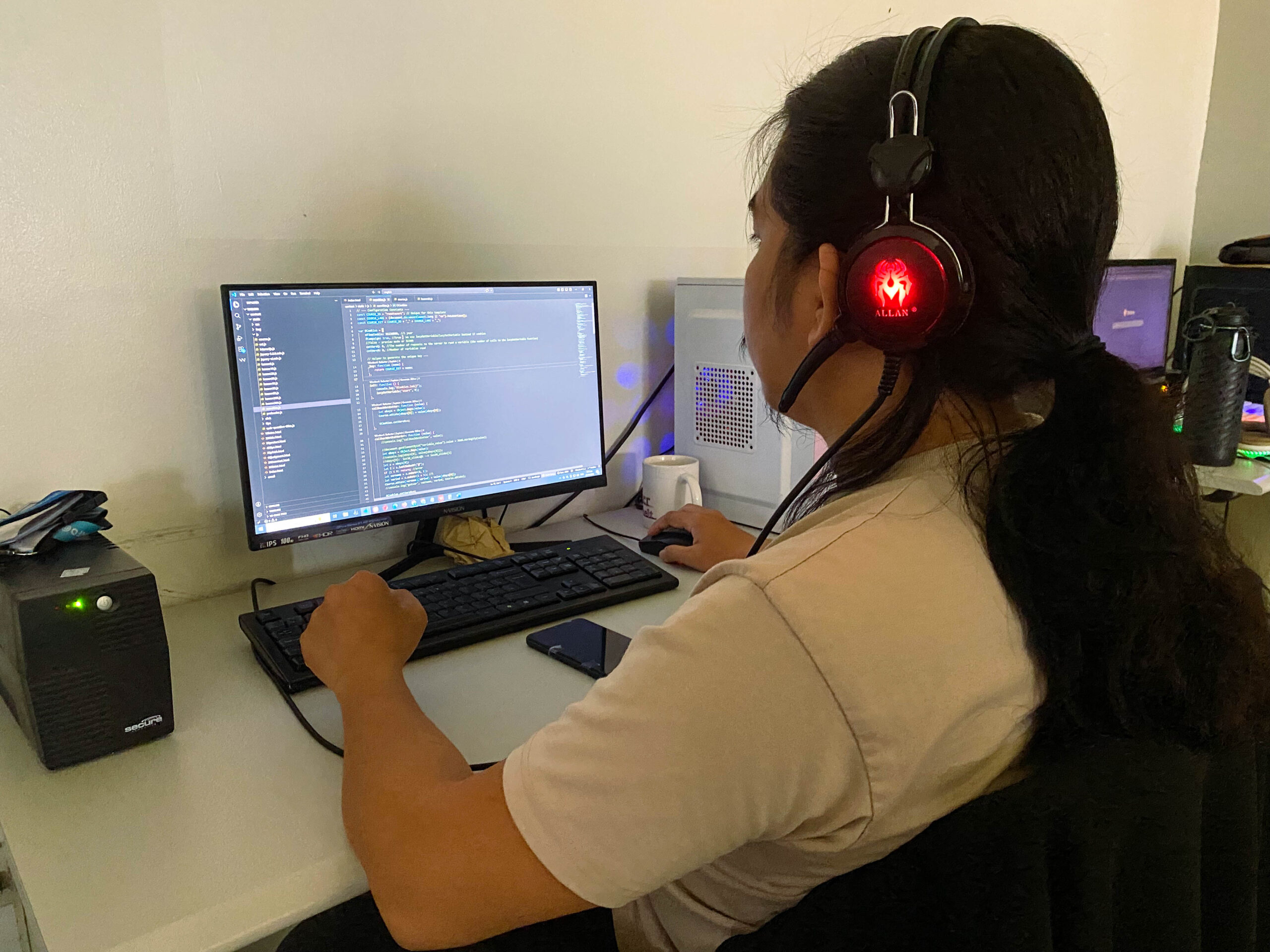 Computer workspace showing a coding interface on screen.