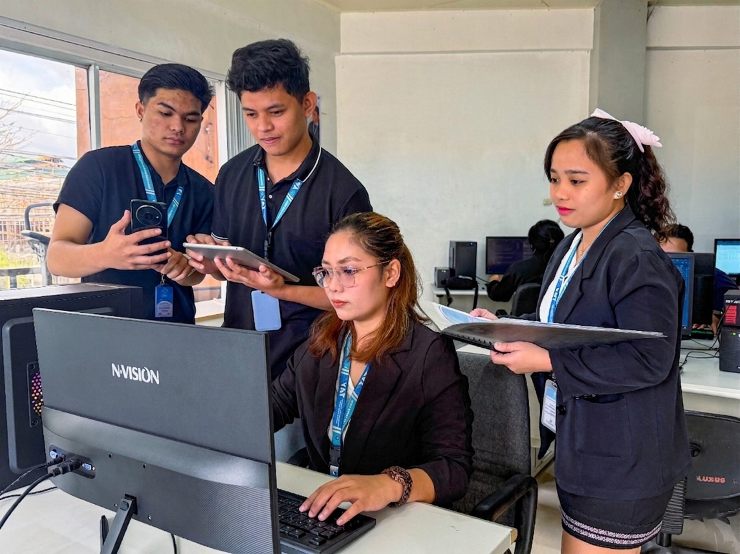 Team members collaborating in an office, focused on tasks and project work.