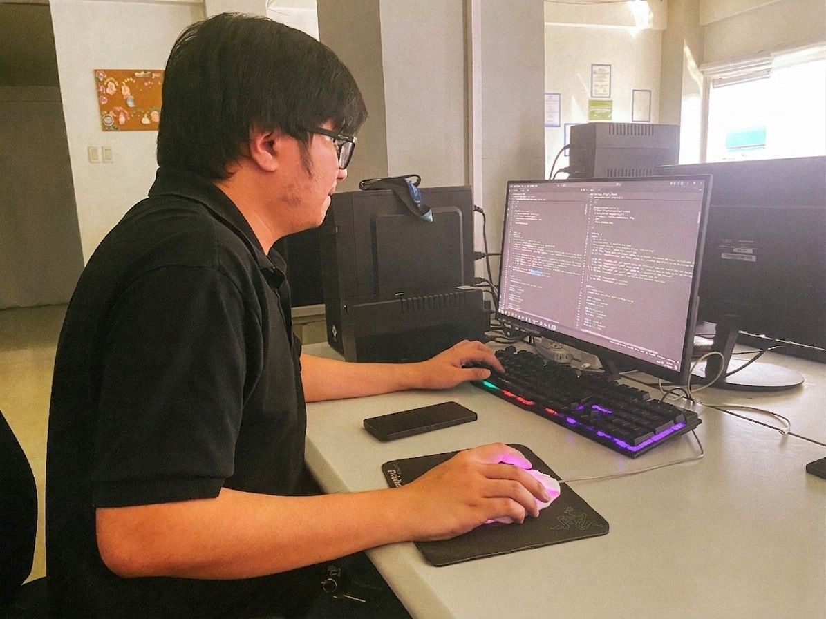 Office scene of a programmer working on coding tasks.